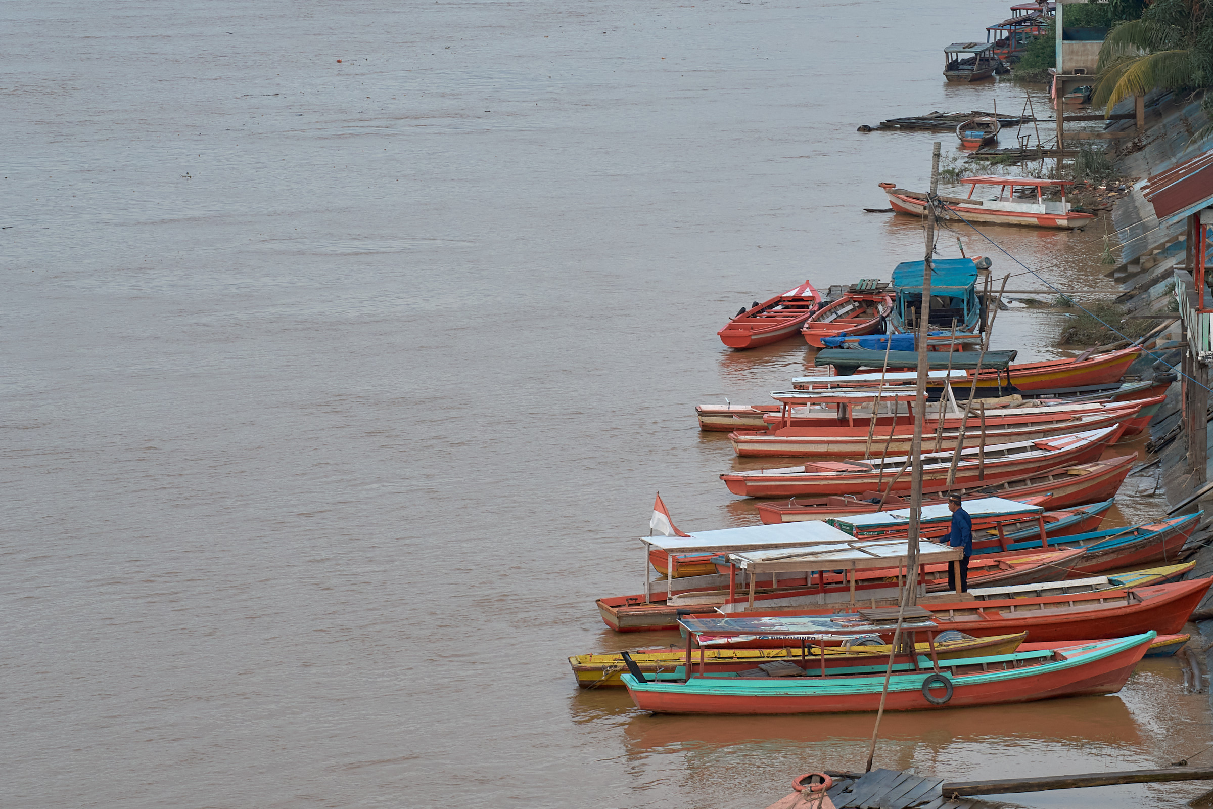 Wooden boats lined along the Batanghari River