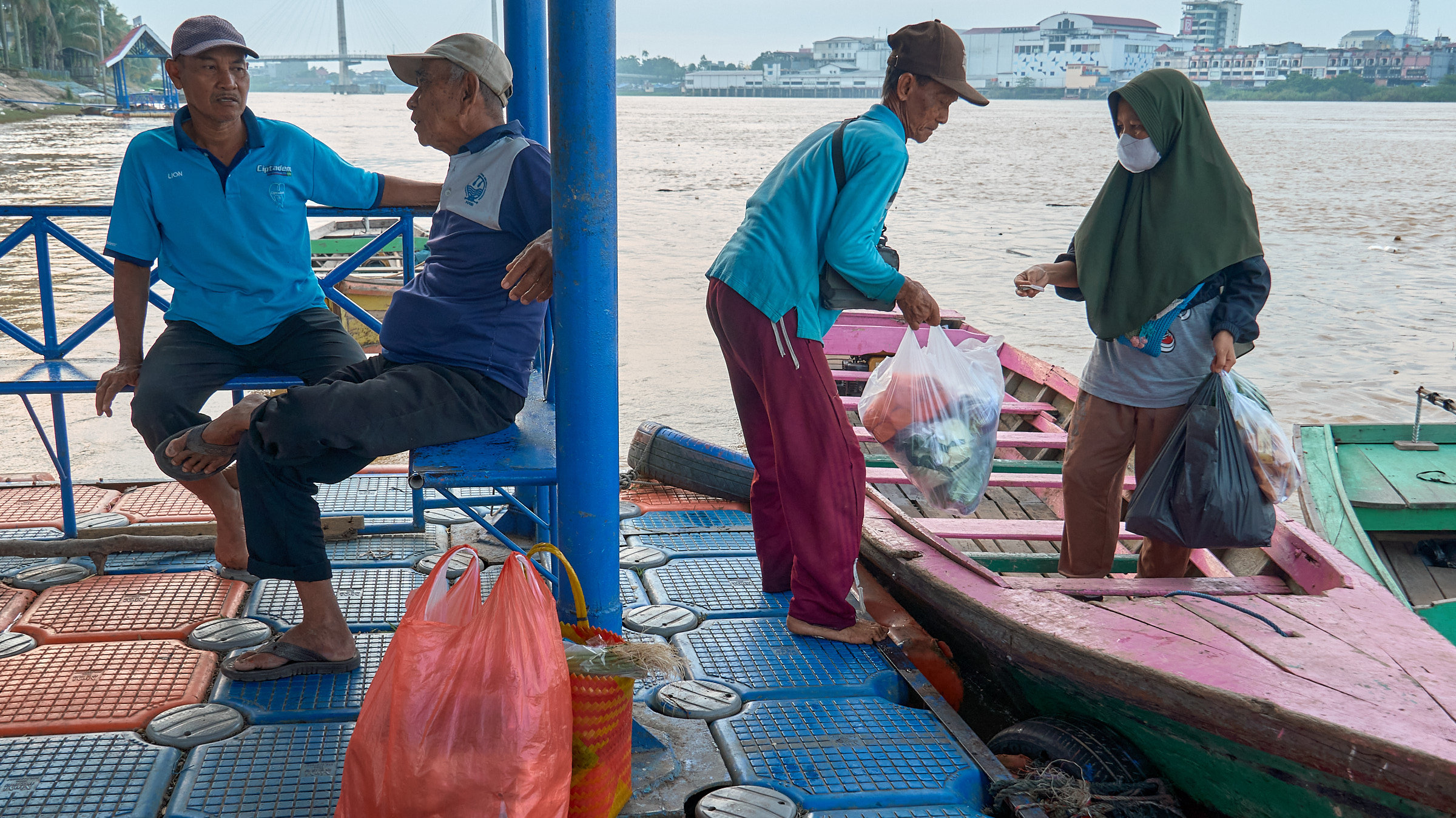 Passengers Boarding Wooden Boats on the Batanghari River