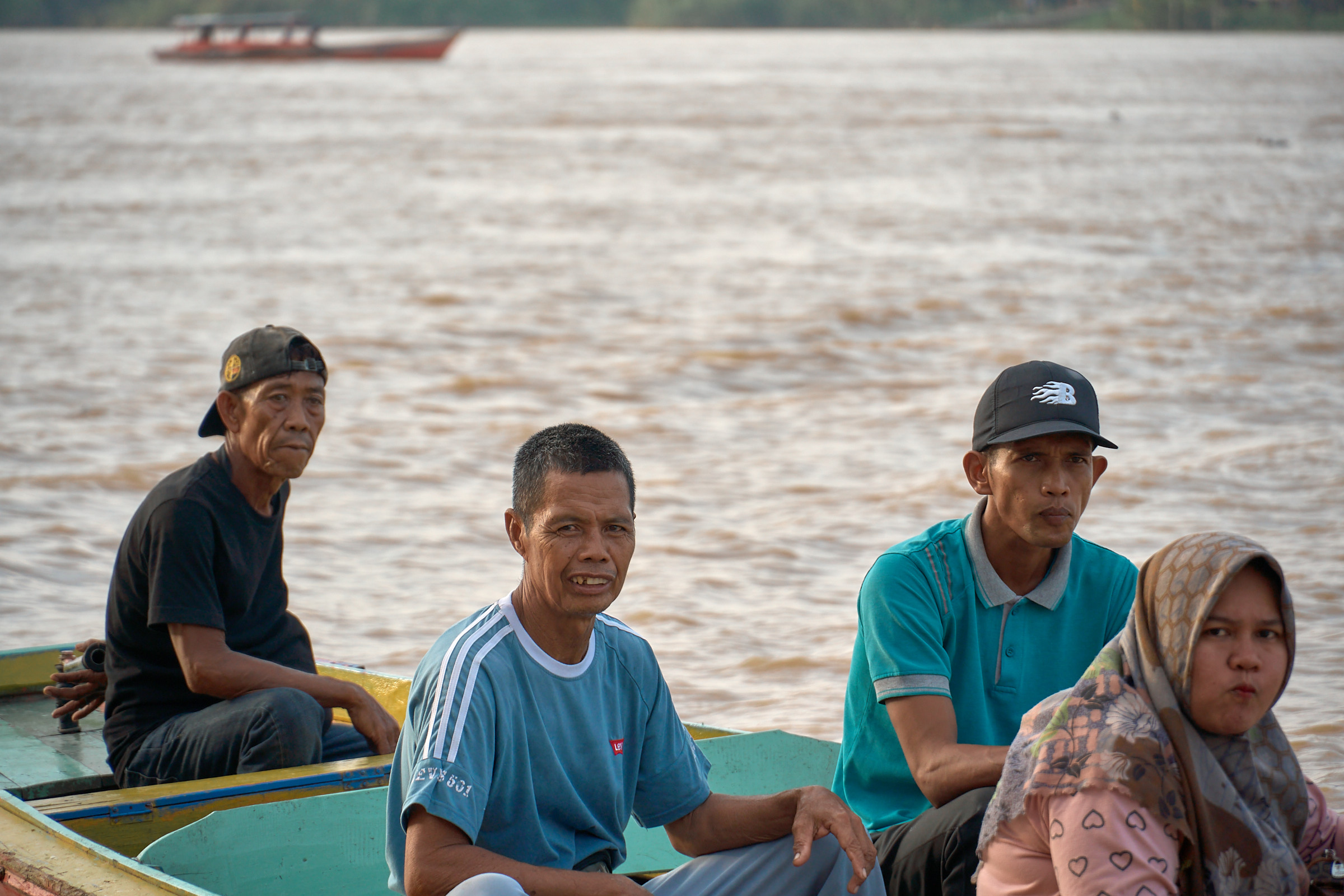 Residents sitting together aboard a wooden boat