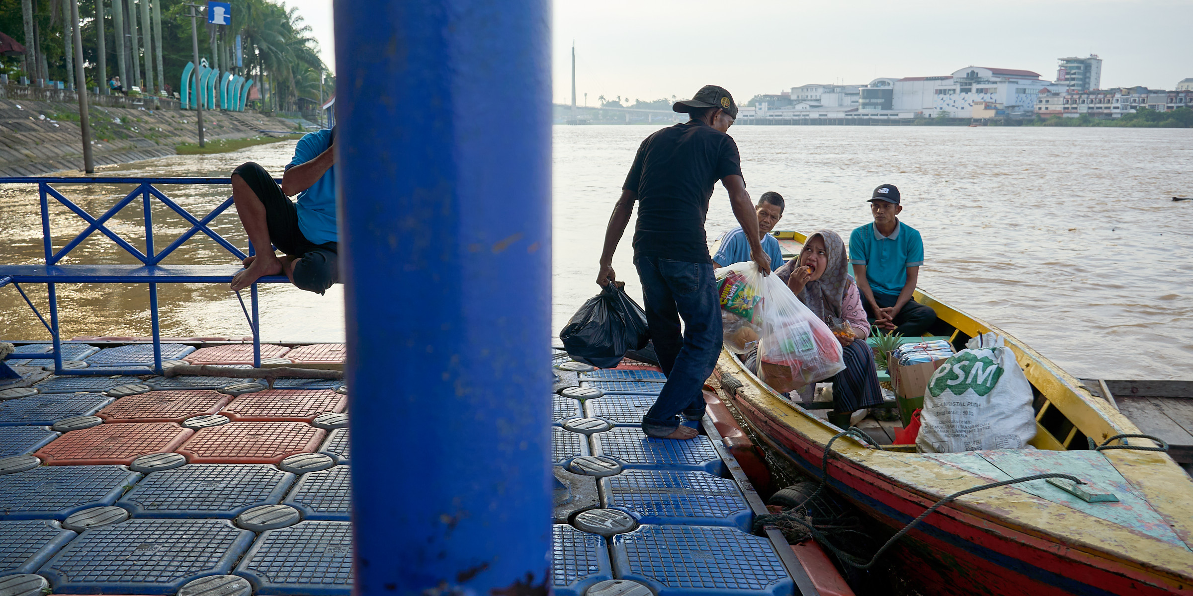 Residents loading goods onto wooden boats